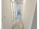 Bright hallway with tile flooring leading to multiple rooms in the home at 3148 Caspian Feather St, Bartow, FL 33830