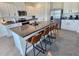 Gourmet kitchen island featuring granite countertops, seating for four, and ample storage space at 3148 Caspian Feather St, Bartow, FL 33830
