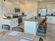 White kitchen cabinets and stainless steel appliances plus an island that seats four. The dining table is nearby at 3148 Caspian Feather St, Bartow, FL 33830