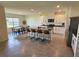 Modern kitchen featuring a large island with seating, stainless steel appliances, and white cabinetry at 3148 Caspian Feather St, Bartow, FL 33830