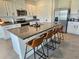 Spacious kitchen featuring a granite island with seating and modern stainless steel appliances at 3148 Caspian Feather St, Bartow, FL 33830