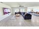 Spacious living room featuring an oversized sectional sofa, large windows, and contemporary decor at 3148 Caspian Feather St, Bartow, FL 33830