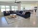 Open-concept living room with a comfortable sectional sofa, decorative rug, and ample natural light at 3148 Caspian Feather St, Bartow, FL 33830