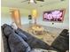 Comfortable living room featuring a plush sofa, area rug, and a flat-screen TV at 3148 Caspian Feather St, Bartow, FL 33830