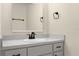 Bathroom vanity with white sink, gray cabinets, neutral paint color and black hardware at 3331 Lime Tree Dr, Edgewater, FL 32141