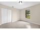 Well-lit bedroom showcasing tile floors, a closet, and a window at 3331 Lime Tree Dr, Edgewater, FL 32141