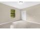 Bright bedroom with a window and closet, featuring neutral walls and tile flooring at 3331 Lime Tree Dr, Edgewater, FL 32141