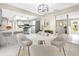 Stylish dining area with a marble table, modern chairs, and an open view to the kitchen and living spaces at 3331 Lime Tree Dr, Edgewater, FL 32141