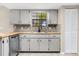 Charming kitchen featuring shaker cabinets, mosaic backsplash, wooden countertops and stainless steel dishwasher at 3331 Lime Tree Dr, Edgewater, FL 32141