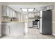Spacious kitchen featuring shaker cabinets, mosaic backsplash, tiled floors and stainless steel appliances at 3331 Lime Tree Dr, Edgewater, FL 32141