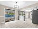 Open-concept kitchen with grey cabinets, an island, a breakfast bar, stainless steel appliances, and a tile backsplash at 3331 Lime Tree Dr, Edgewater, FL 32141