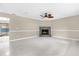 Open living space featuring a fireplace, tile floors, a ceiling fan, and views into adjoining rooms at 3331 Lime Tree Dr, Edgewater, FL 32141