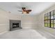 Cozy living room with a fireplace, tile floors, a ceiling fan, and a large window at 3331 Lime Tree Dr, Edgewater, FL 32141
