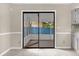 Tile floor access to a screened-in porch with a blue privacy fence, and a sliding glass door at 3331 Lime Tree Dr, Edgewater, FL 32141
