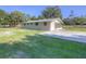 Rear exterior view of this home with a screened porch and a large yard at 3550 Keen Dr, Mulberry, FL 33860