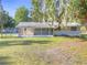 Charming single-story home with a screened porch and lush green lawn at 3550 Keen Dr, Mulberry, FL 33860