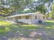 Classic home featuring a screened porch and partially fenced yard at 3550 Keen Dr, Mulberry, FL 33860