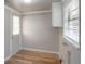 This laundry area features wood floors, storage cabinets, and a door to the exterior at 3550 Keen Dr, Mulberry, FL 33860