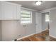 This laundry area features wood floors, built-in cabinets, and utility hookups at 3550 Keen Dr, Mulberry, FL 33860