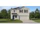 Charming two-story home featuring a two-car garage and well-manicured lawn at 979 Hour Glass Rd, Lakeland, FL 33801