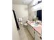 Clean bathroom with a neutral color scheme, tile flooring, and essential fixtures at 1310 Payne St, Auburndale, FL 33823