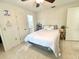 Cozy bedroom featuring a bed, tiled floors, and access to an ensuite bathroom at 1310 Payne St, Auburndale, FL 33823