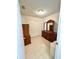 Neat bedroom with tiled floor, standard closet doors, and classic wood furniture at 1310 Payne St, Auburndale, FL 33823