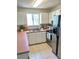 Functional kitchen featuring stainless steel appliances and ample cabinet space with a window view at 1310 Payne St, Auburndale, FL 33823
