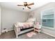 Cozy bedroom with neutral walls, a ceiling fan, and a bright window at 6050 Eagle Pointe Dr, Lakeland, FL 33812
