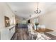 Bright dining room with wood table, white chairs, and view into the living space at 6050 Eagle Pointe Dr, Lakeland, FL 33812