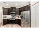 Modern kitchen featuring stainless steel appliances and dark cabinets, providing ample storage at 6050 Eagle Pointe Dr, Lakeland, FL 33812