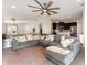 Open-concept living room with a large sectional sofa and view of the kitchen and dining area at 6050 Eagle Pointe Dr, Lakeland, FL 33812