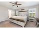 Main bedroom featuring a statement headboard and bright windows with plantation shutters at 6050 Eagle Pointe Dr, Lakeland, FL 33812