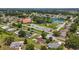 Aerial view showcases the community clubhouse, pool, and tennis courts at 9755 Se 176Th St, Summerfield, FL 34491