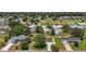 Aerial view of a well maintained home with a lush lawn and mature trees at 9755 Se 176Th St, Summerfield, FL 34491