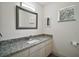 Bathroom featuring a vanity with granite countertop, window, and modern lighting at 9755 Se 176Th St, Summerfield, FL 34491