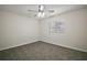 Bedroom features neutral walls, carpet, ceiling fan, and bright window at 9755 Se 176Th St, Summerfield, FL 34491