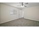 Bright bedroom with plush carpeting, neutral walls, and a large window at 9755 Se 176Th St, Summerfield, FL 34491