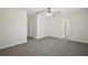 Spacious bedroom with gray carpet flooring, ceiling fan, and neutral paint at 9755 Se 176Th St, Summerfield, FL 34491
