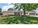 Well-maintained single-story home with a manicured lawn and lush landscaping at 9755 Se 176Th St, Summerfield, FL 34491