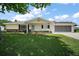 Charming single-story home featuring a well-kept lawn and a screened-in garage at 9755 Se 176Th St, Summerfield, FL 34491