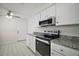 Kitchen showcasing white cabinets, modern appliances, and granite countertops at 9755 Se 176Th St, Summerfield, FL 34491