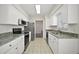 Bright kitchen featuring white cabinets, stainless steel appliances, and granite countertops at 9755 Se 176Th St, Summerfield, FL 34491