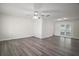 Spacious living room features neutral walls, a ceiling fan, and modern flooring at 9755 Se 176Th St, Summerfield, FL 34491