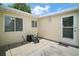 Back patio area featuring an outdoor door, windows, and a pressure washer at 9755 Se 176Th St, Summerfield, FL 34491