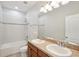Bright bathroom featuring double vanity sinks, tile flooring, and a shower-tub combination at 3848 Spirited Cir, St Cloud, FL 34772