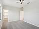 A serene bedroom features a ceiling fan, neutral walls, and a walk-in closet with built-in shelving at 3848 Spirited Cir, St Cloud, FL 34772