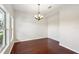 Bright dining room featuring wood floors, a chandelier, and ample natural light at 3848 Spirited Cir, St Cloud, FL 34772
