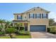 Inviting two-story home with a well-manicured lawn, brick driveway, and covered entryway at 3848 Spirited Cir, St Cloud, FL 34772