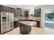 Modern kitchen with stainless steel appliances, granite countertops, and a central island at 3848 Spirited Cir, St Cloud, FL 34772